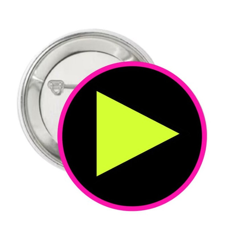 May include: A black button with a pink border and a bright yellow play button in the center.