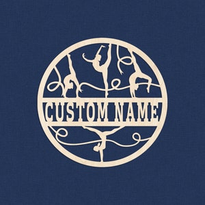 May include: A wooden circle with a cutout design of four gymnasts performing with ribbons. The text "CUSTOM NAME" is in the center of the circle.