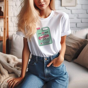 May include: White t-shirt with a graphic of a green and pink cleaning product label that says "Bookish Fuel" and "Up to Reading".