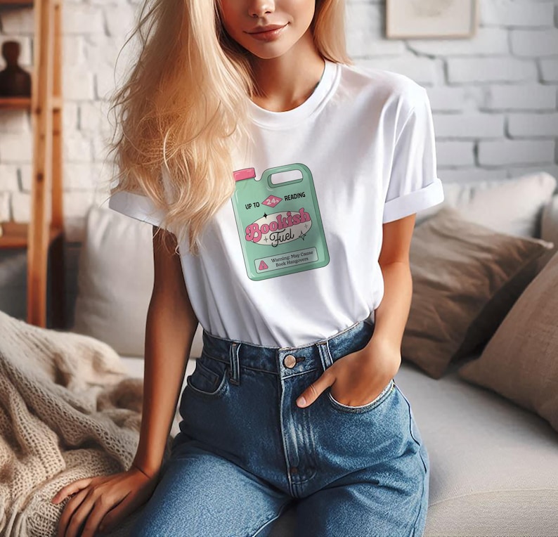 May include: White t-shirt with a graphic of a green and pink cleaning product label that says "Bookish Fuel" and "Up to Reading".