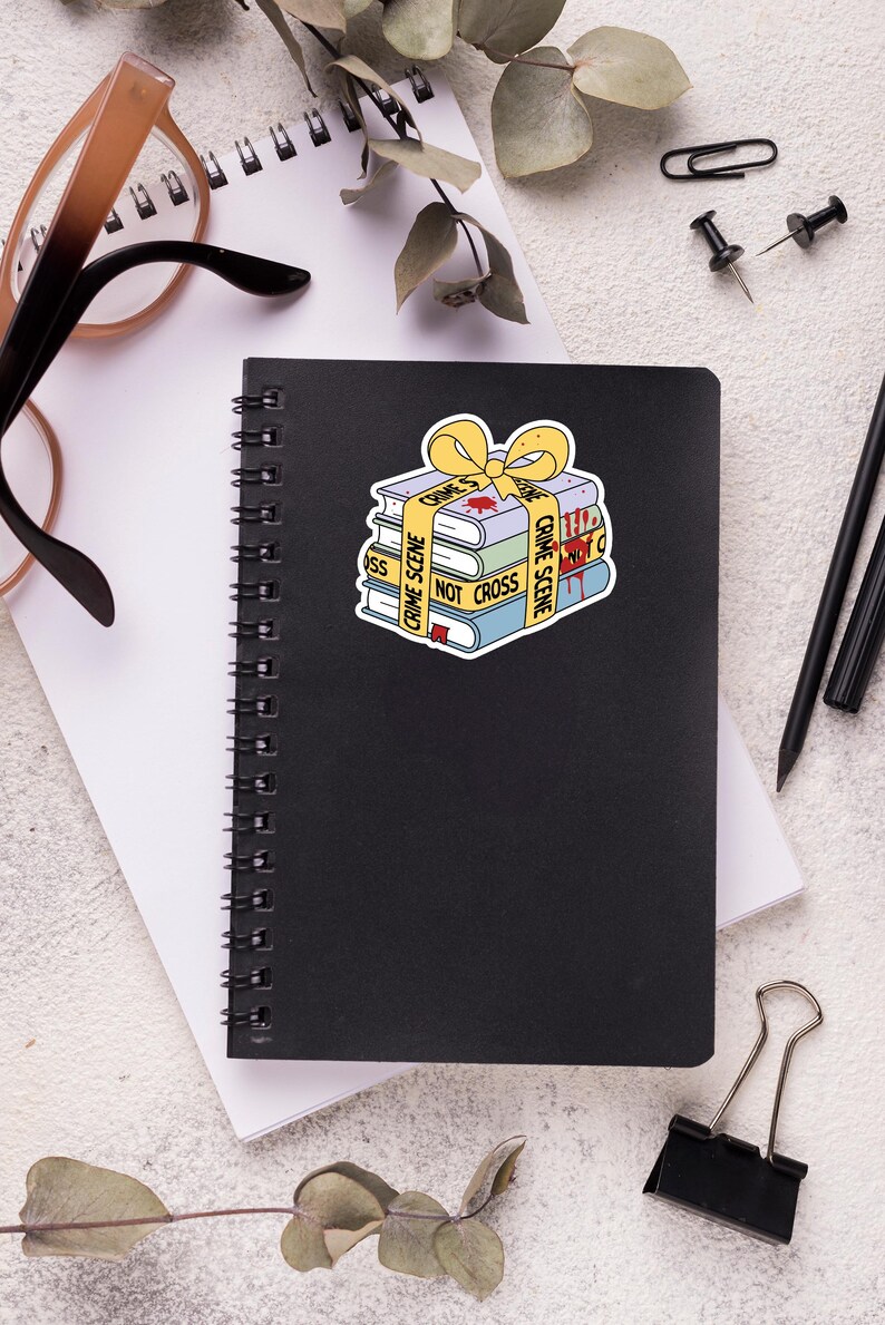 May include: A stack of books wrapped in yellow crime scene tape with a red bow. The tape reads "Crime Scene Do Not Cross".