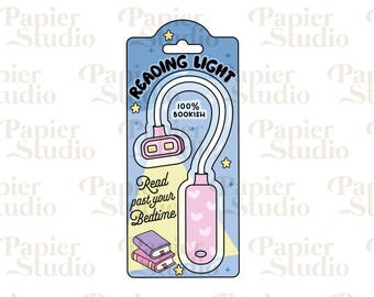 May include: A blue and white package with a pink and white reading light. The light is shaped like a flexible neck lamp with a heart-shaped base. The package says "Reading Light" and "100% Bookish".