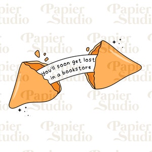 May include: A fortune cookie with a message that reads "You'll soon get lost in a bookstore". The cookie is broken open and the message is visible.
