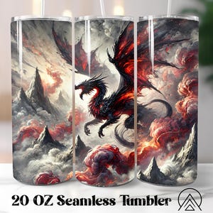 May include: A 20 oz seamless tumbler with a fantasy dragon design. The artwork shows a black and red dragon flying in a dramatic, cloudy landscape with mountain peaks. The tumbler has a white straw.