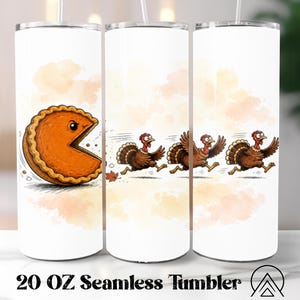 May include: A white 20 oz seamless tumbler featuring a cartoon illustration of a pumpkin pie slice with a face chasing three brown turkeys. The design includes soft orange watercolor accents and a clear straw extending from the top lid.