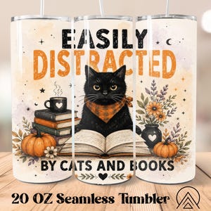 May include: A 20 oz cylindrical tumbler featuring a black cat wearing an orange plaid bandana, reading an open book. The design includes stacks of books, pumpkins, a coffee mug, and flowers, with the text EASILY DISTRACTED BY CATS AND BOOKS.