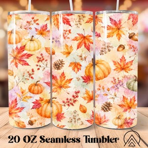 May include: A cylindrical 20 oz stainless steel tumbler featuring a seamless watercolor print of orange pumpkins, red and yellow maple leaves, brown pinecones, and small berries against a light cream background with a clear plastic lid.
