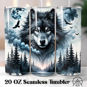May include: A 20 oz seamless tumbler featuring a detailed illustration of a wolf's face, set against a backdrop of a moonlit forest with flying birds and clouds. The design is predominantly black, white, and shades of blue.