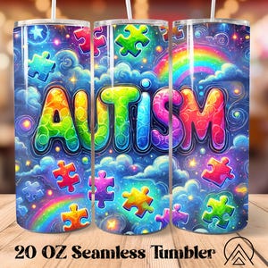 May include: A 20 oz seamless tumbler with a vibrant design. The tumbler features the word "AUTISM" in colorful bubble letters, surrounded by puzzle pieces, rainbows, stars, and clouds. The design is set against a dark blue background.