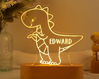 May include: A wooden night light shaped like a dinosaur with the name "EDWARD" inscribed on the side. The light is illuminated with a warm yellow glow.