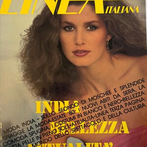 May include: A vintage cover of "Linea Italiana" magazine. The image shows a woman with brown hair and a pink top. The magazine title is in yellow, with the text "THE ITALIAN FASHION MAGAZINE" and "ENGLISH TEXT". Italian text is also visible.