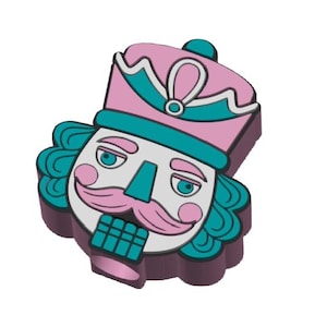 May include: A colorful nutcracker figurine with a pink hat and teal accents. The figurine has a white face, a pink mustache, and teal hair. The nutcracker's mouth is a teal color.