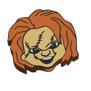 May include: A cartoon-style image of Chucky's face, featuring orange hair, tan skin, and black stitched scars. The character has a sinister grin and black eyes, set against a white background. The overall design is a stylized representation of the horror movie character.