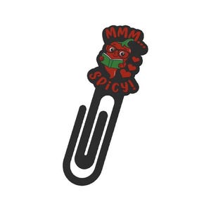 May include: A black metal paperclip with a red chili pepper design. The chili pepper is wearing glasses and reading a green book. The text "MMM... Spicy!" is above and below the pepper.