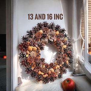 May include: A brown and beige autumnal wreath made of pine cones, nuts, and dried flowers. The wreath is 13 and 16 inches in diameter.
