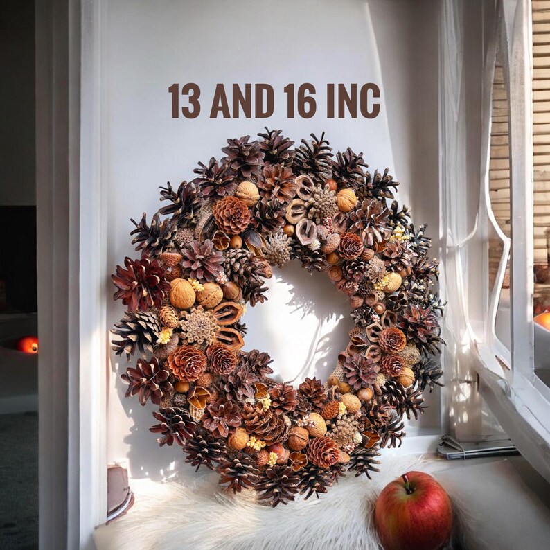 May include: A brown and beige autumnal wreath made of pine cones, nuts, and dried flowers. The wreath is 13 and 16 inches in diameter.