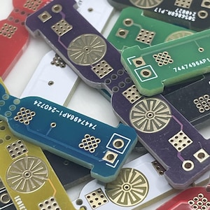 May include: Assortment of colourful circuit boards with gold-plated components and text, including "7447496AP1-Z40Z4" and "50599903-P17".