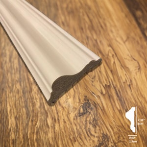 May include: White decorative molding with a slightly curved edge. The molding is 2.36 inches wide and 0.90 inches tall.