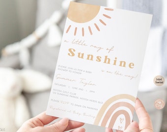 Puede incluir: Una invitación a una fiesta de bienvenida al bebé con un diseño de sol y arcoíris. El texto dice "a little ray of sunshine is on the way!" e incluye el nombre "Summer Taylor" y la fecha y hora de la fiesta.