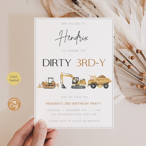 May include: A white card with a construction theme birthday party invitation for a boy turning three. The invitation features a handwritten name "Hendrix" and the text "Can you dig it?"  "Is turning the Dirty 3rd-Y" and a row of construction vehicles. The invitation also includes the date, time, and location of the party.