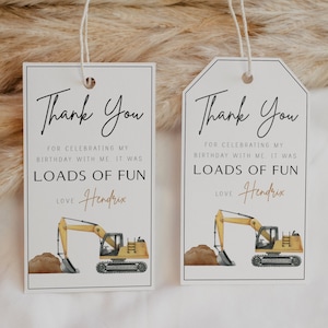 May include: Two white thank you tags with black text. The tags feature a yellow excavator with brown dirt. The text reads "Thank You for celebrating my birthday with me. It was loads of fun. Love Hendrix".