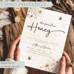 May include: A white bridal shower invitation with a honeycomb pattern and floral accents. The text reads "She found her Honey" and includes details for the event, such as the date, time, and location.