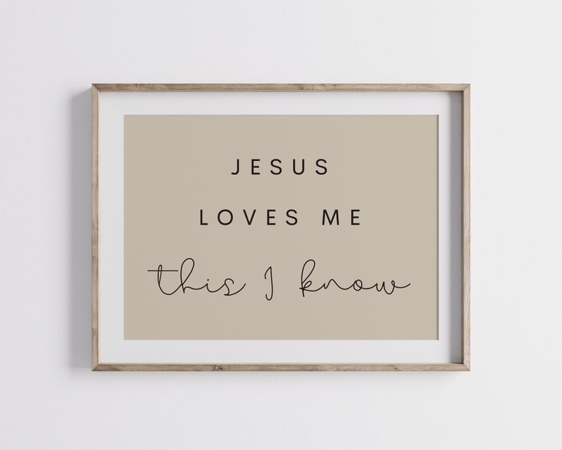 May include: A beige framed print with the text "JESUS LOVES ME this I know" in black.