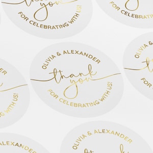 May include: Round white stickers with gold foil lettering that says "Thank you for celebrating with us!" and "Olivia & Alexander".