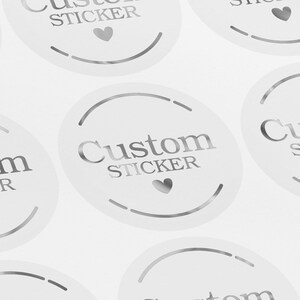 May include: Silver holographic stickers with the text "Custom Sticker" and a small heart design.
