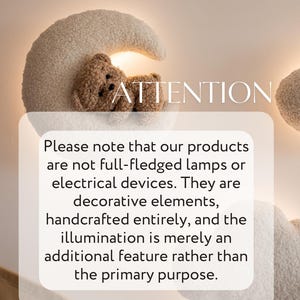 May include: A decorative wall lamp shaped like a crescent moon with a teddy bear. The lamp is made of a soft, textured material in cream and brown tones. The text "ATTENTION" is visible.