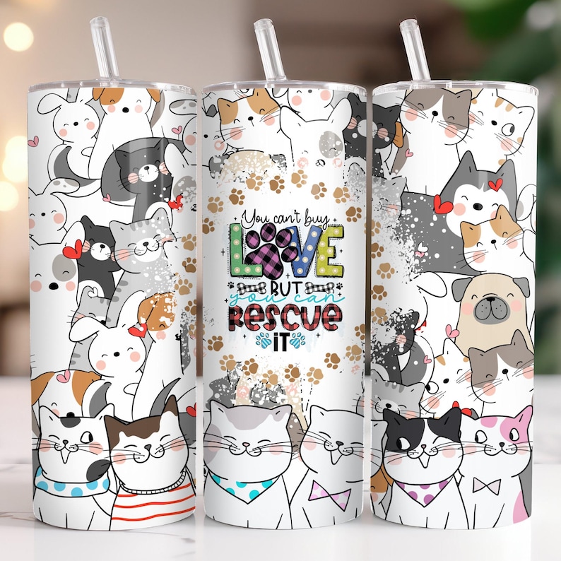 May include: Three white stainless steel tumblers with a colorful cartoon design of cats and dogs. The middle tumbler has the text "You can't buy love but you can rescue it" with a paw print and plaid design.