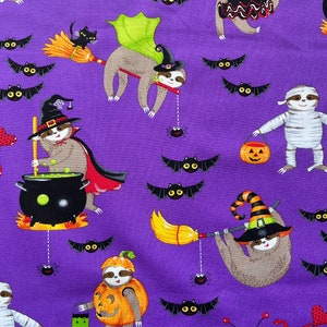 May include: Purple fabric with a repeating pattern of sloths dressed in various Halloween costumes, including a witch, a pumpkin, a mummy, and a ladybird. Bats and spiders are also included in the design.