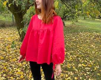 red blouse with ruffled sleeves