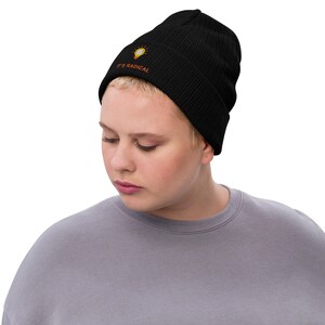 May include: Black beanie with a lightbulb graphic and the text "IT'S RADICAL" in orange.