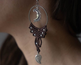 May include: Brown macrame earrings with a silver crescent moon charm and a silver leaf dangle.