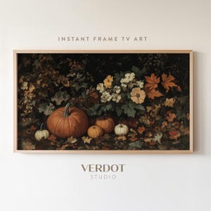 May include: A framed painting of a still life featuring pumpkins and flowers. The pumpkins are orange and the flowers are white and yellow. The background is a dark green and brown.