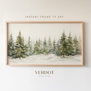 Puede incluir: Una pintura de acuarela enmarcada de una escena de bosque nevado con pinos verdes. La pintura está en un marco de madera claro y tiene el texto "INSTANT FRAME TV ART" en la parte superior.