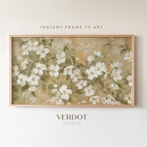 May include: A framed painting of white flowers with green leaves on a beige background. The painting is in a light wood frame.