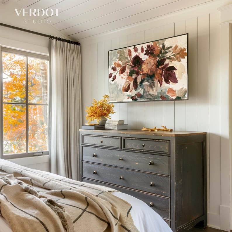 May include: A rectangular wall art print featuring an oil painting of a floral bouquet in shades of deep burgundy, burnt orange, and muted green. The artwork is displayed in a thin black frame above a dark gray wooden dresser with six drawers.