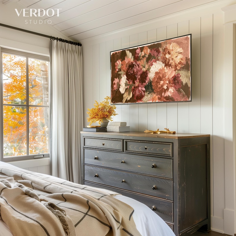 May include: A rectangular wall art print featuring a floral arrangement in shades of deep red, burgundy, and cream. The artwork is displayed above a dark charcoal wooden dresser with six drawers, positioned in a room with white vertical wall paneling.