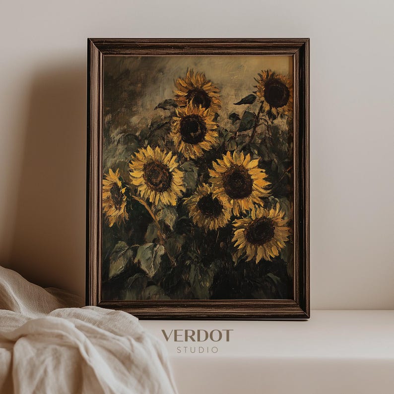 May include: A framed painting of a bouquet of sunflowers in shades of yellow and brown. The sunflowers are arranged in a vase and are surrounded by green leaves. The painting is set against a light brown background.