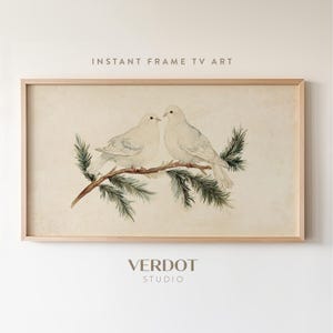 May include: A watercolor painting of two white doves perched on a branch of pine needles. The doves are facing each other and appear to be in a loving embrace. The background is a soft beige color.
