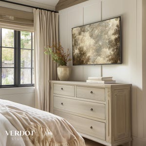 May include: A light wood dresser with five drawers and black metal drawer pulls. The dresser is in a bedroom with a bed, a window with white curtains, and a framed painting of a cloudy sky above the dresser.
