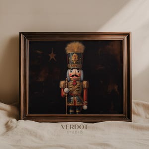 May include: A framed painting of a traditional wooden nutcracker soldier. The nutcracker is wearing a red and green uniform with gold trim and a blue and gold hat. The background is dark with a star in the top left corner.