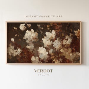 May include: A framed painting of white and cream-coloured flowers against a dark background. The artwork is labelled "INSTANT FRAME TV ART" and "VERDOT STUDIO". The painting has a vintage, impressionistic style.