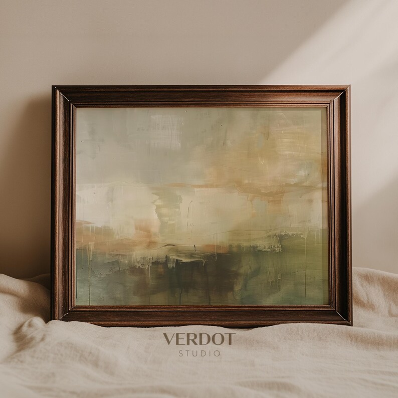 May include: A framed abstract painting with muted green, brown, and beige colors. The painting is in a dark wood frame and is hanging on a wall.