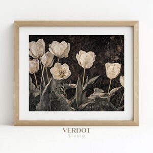 May include: A framed print of a vintage-style photograph featuring a bouquet of white tulips against a dark background. The tulips are arranged in a cluster, with their stems and leaves visible. The image has a soft, faded look, giving it a vintage feel.