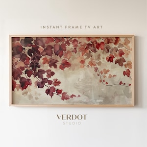 Puede incluir: Una pintura de acuarela enmarcada de una vid con hojas rojas y marrones sobre un fondo beige claro. La pintura se titula "Instant Frame TV Art" y está firmada "Verdot Studio".
