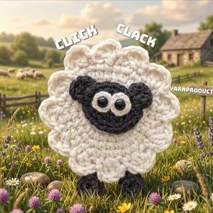 May include: A crocheted sheep with a white body and a black face, ears, and feet. The sheep has large, round eyes and is standing in a field of wildflowers. The words "CLICK" and "CLACK" are above the sheep.