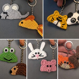 May include: A collection of handmade crochet animal keychains featuring various designs including a grey mouse, orange goldfish, yellow tiger, black and white panda, green frog, brown bear, white rabbit, and pink pig, each attached to a silver metal ring.